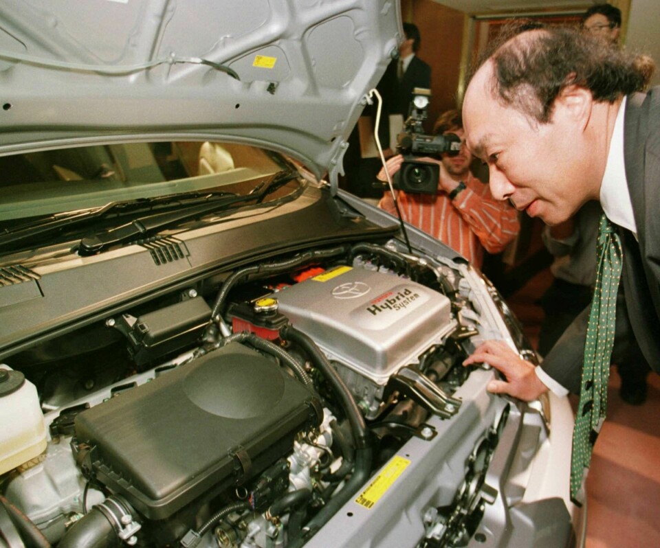 En motorjournalist tittar under huven på Toyotas hybridbil Prius under lanseringen 1997. Foto: ITSUO INOUYE/TT