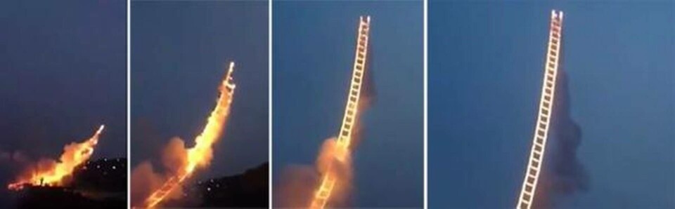 En vajerkonstruktion som bärs upp av en heliumballong och är försedd med pyroteknik bygger stegen upp i himlen. Foto: Teetoo En vajerkonstruktion som bärs upp av en heliumballong och är försedd med pyroteknik bygger stegen upp i himlen. Foto: Teetoo