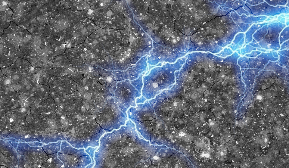 Ett blått lysande nätverk syns inuti ett grått material.