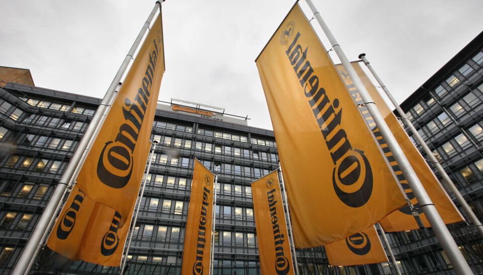 Continental ska spara 400 miljoner euro om året. Arkivbild. Orangea flaggor framför en mörk byggnad. På flaggorna står det Continental.