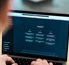 Close view of a man with opened AI chat on laptop