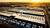 Luftfoto av AWS MLZ-datacenter och omgivande industriområde i solnedgång.